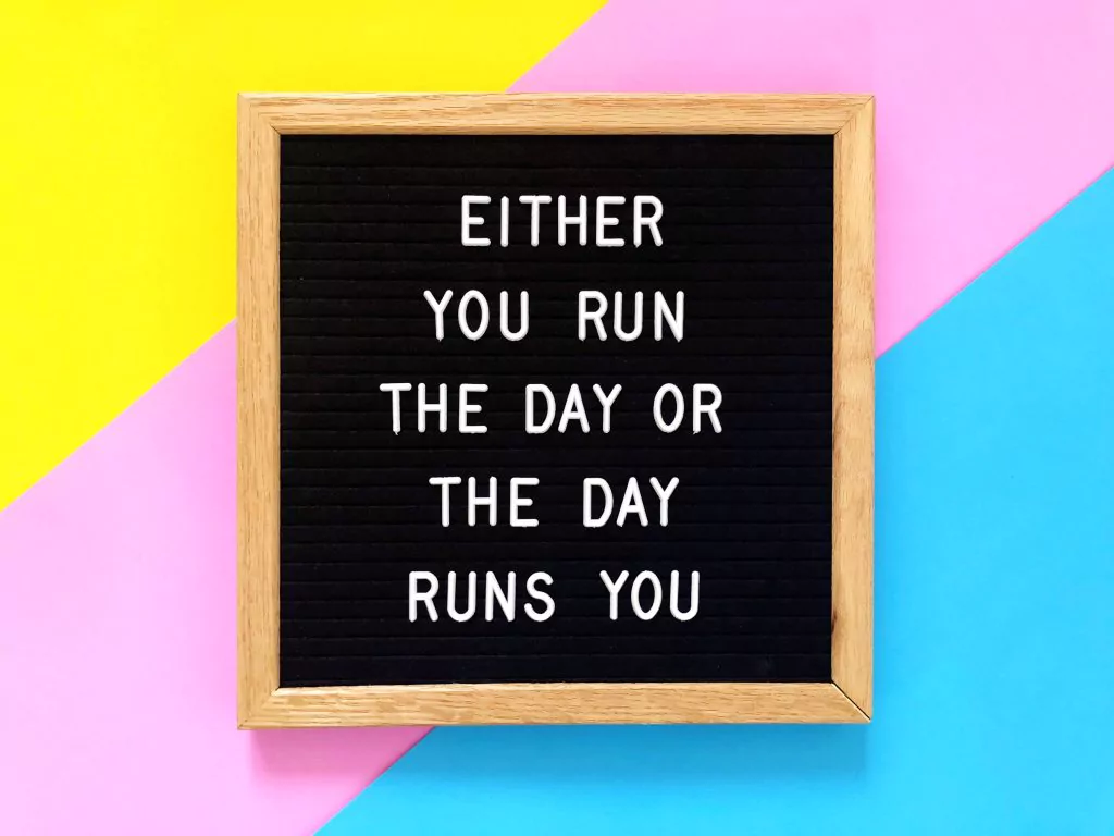 Schild mit Spruch: Either you run the day or the day runs you